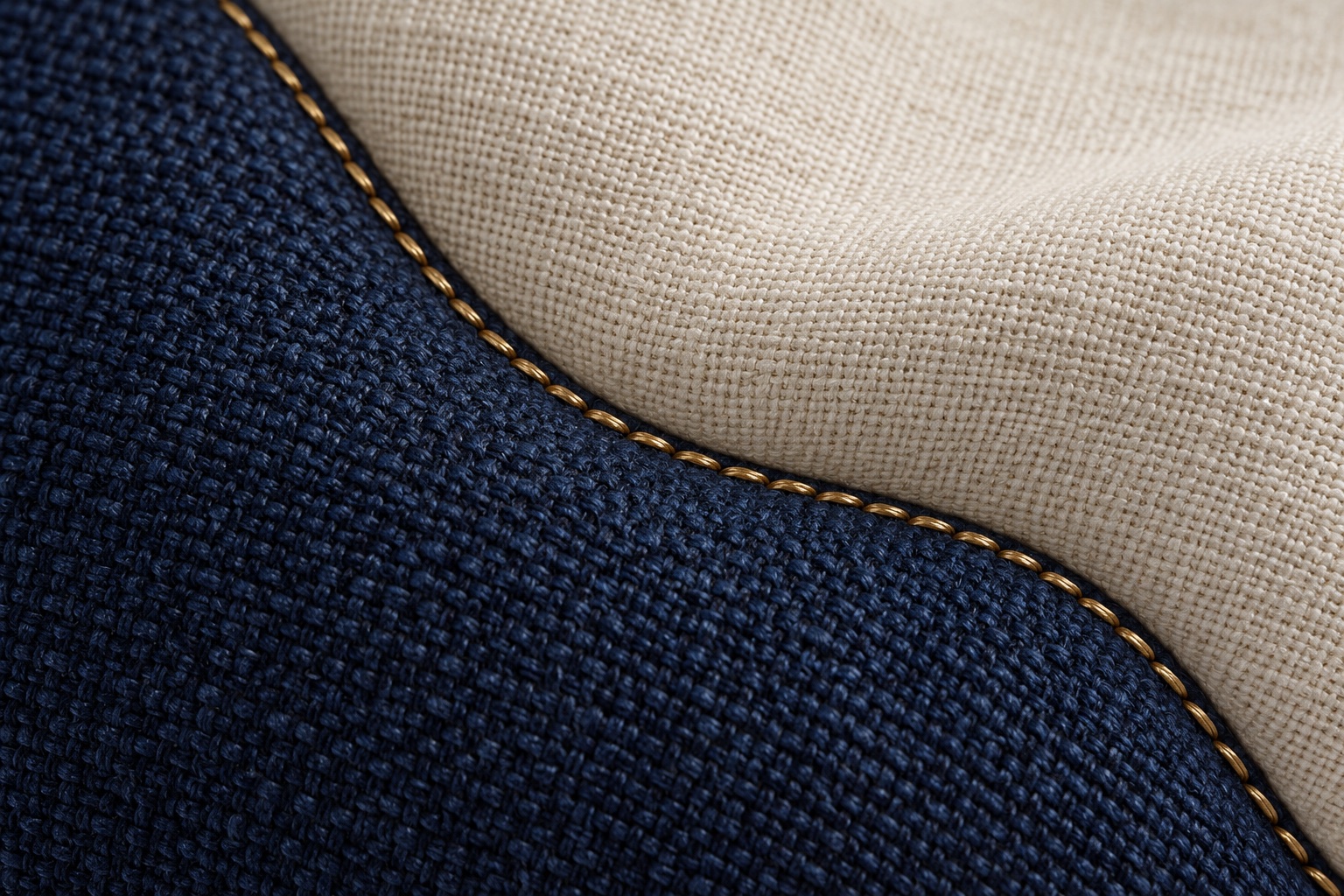 Illustrative navy and ivory textile joined by a curved brass-colored seam